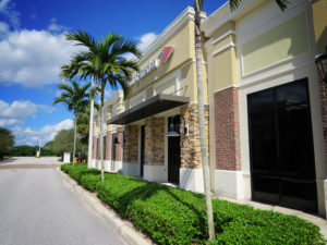 This image depicts a Bank of America building with a brown canopy.