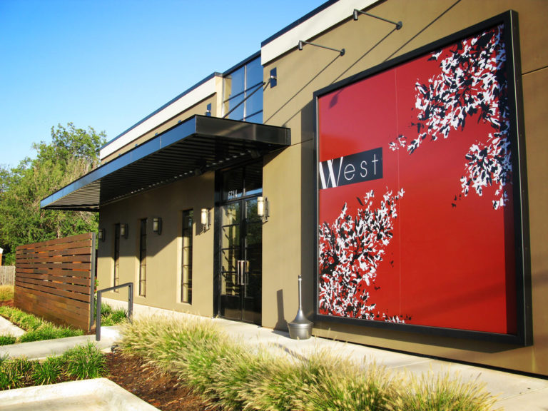 This image depicts a black Mapes canopy over the entrance to a restaurant.
