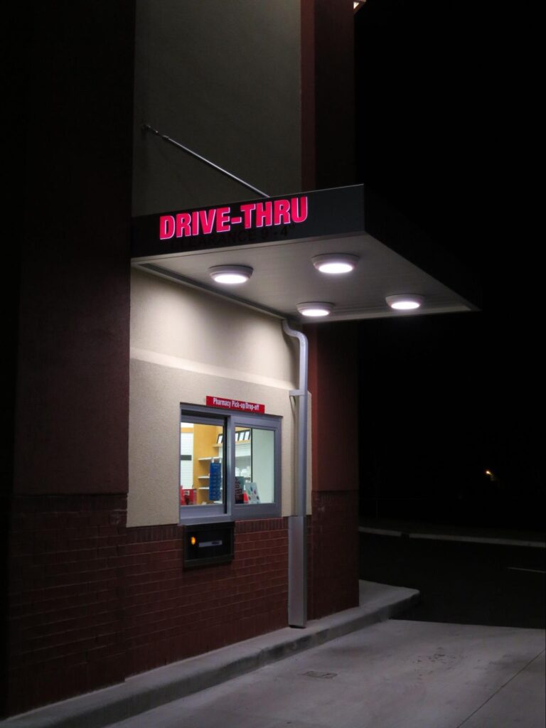 A CVS drive-thru has a custom canopy with integrated lighting for added safety. 
