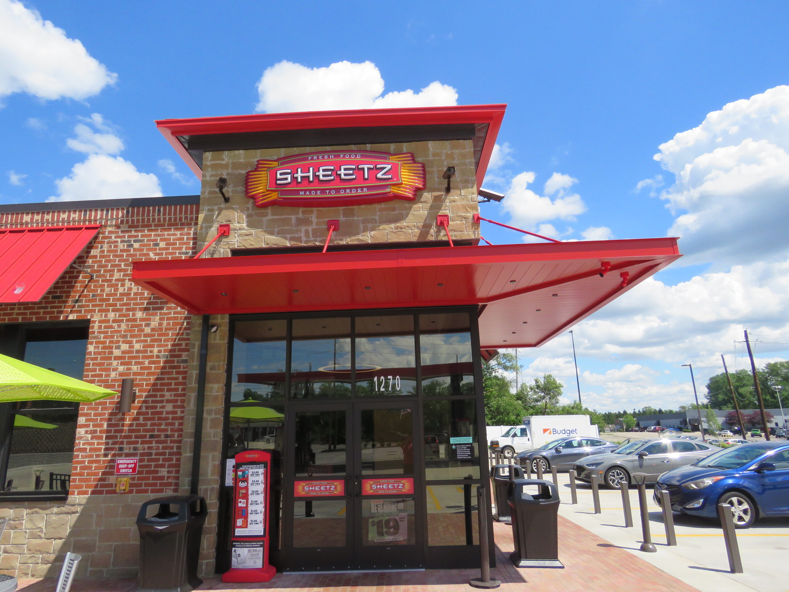 This image depicts a Sheetz storefront with its classic red branding utilized on a Mapes canopy.